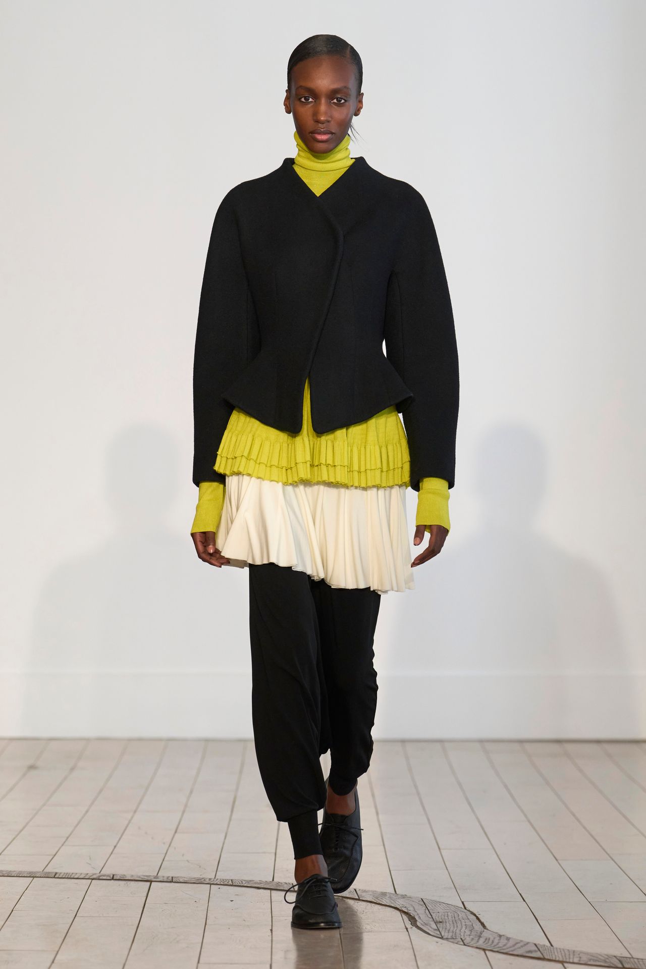 Image may contain Clothing Knitwear Sweater Adult Person Coat Skirt Jacket and Standing