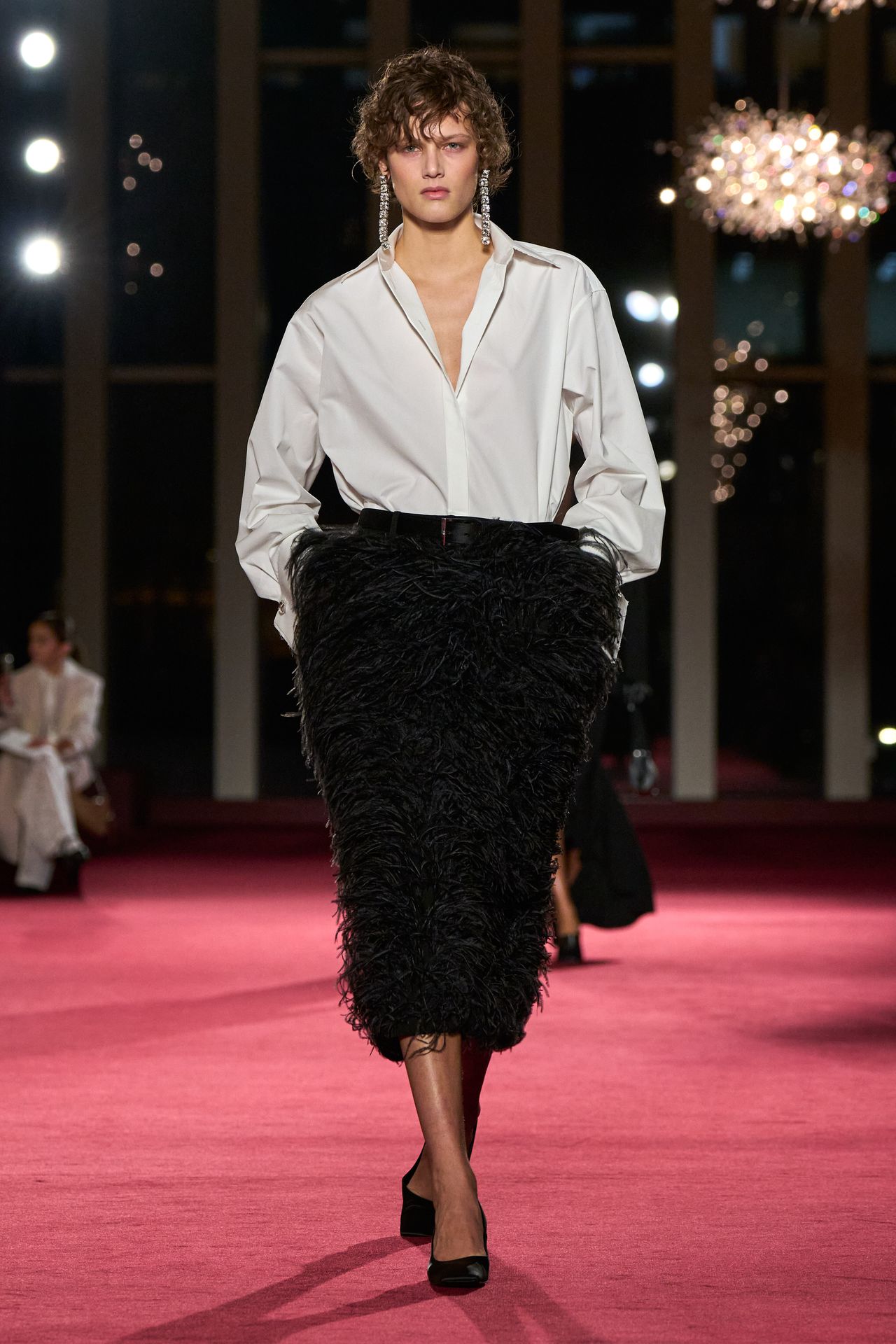 Image may contain Fashion Adult Person Clothing Skirt Formal Wear Suit and Coat